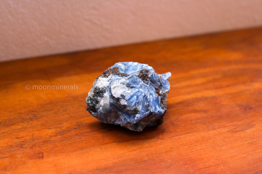 Rounded Blue Kyanite Cluster, Palmsized sitting standalone with white, red and black inclusions 