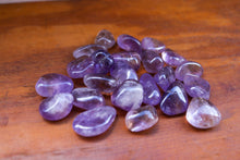 Load image into Gallery viewer, A Pile of Light Purple Ametrine Tumbles with slight yellow inclusions
