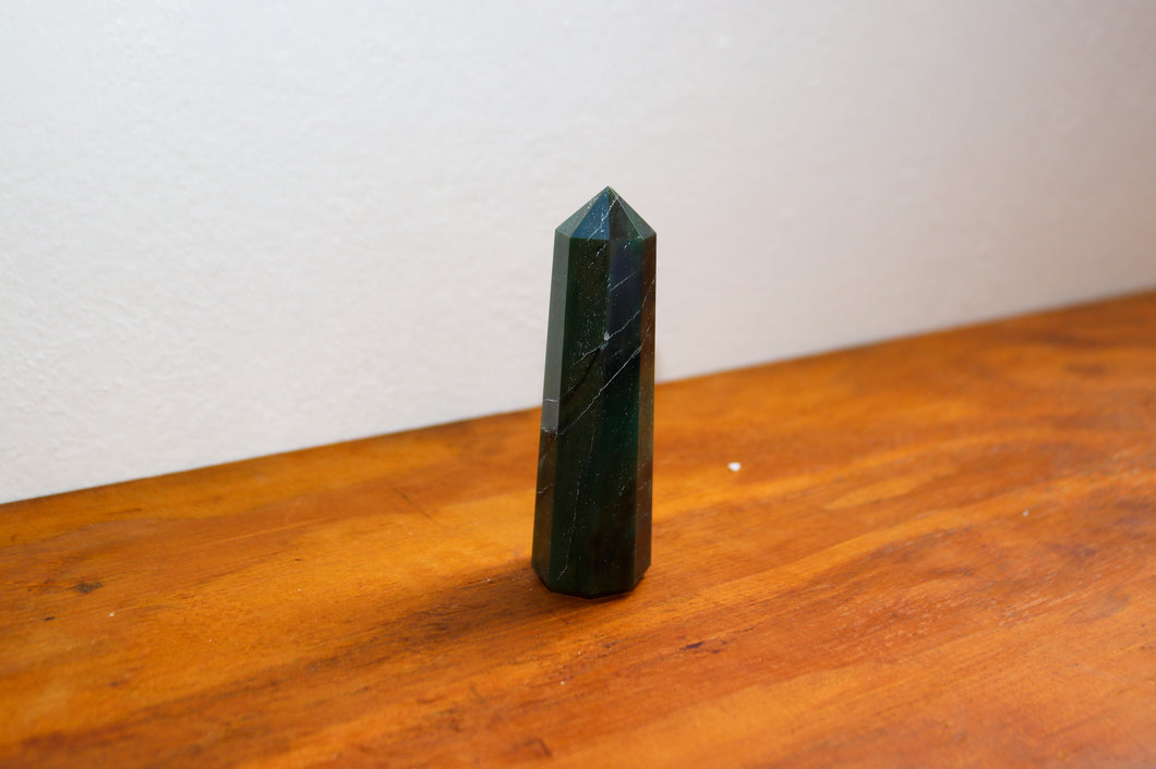 Deep Emerald Green Aventurine Tower (point) sitting atop an orange bench