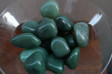 Load image into Gallery viewer, Handful of Green Aventurine Tumbles variying in shades of Green, placed in a clear martini glass

