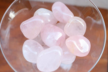 Load image into Gallery viewer, Birds eye - A handful of Blush Light Pink Rose Quartz Tumbles, held in a clear martini glass
