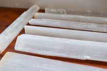Load image into Gallery viewer, Long Selenite bars (wands) laid out next to one anothe to show size, white colour with some yellow inclusions
